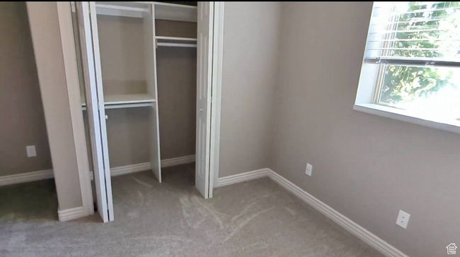 Unfurnished bedroom with a closet, carpet flooring, and baseboards | Image 41