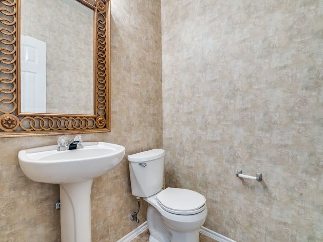 Bathroom with toilet and baseboards | Image 12