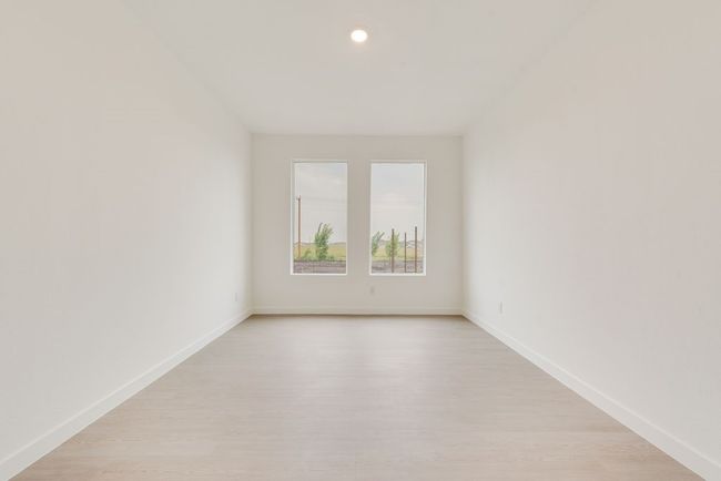 Empty room with light wood-style flooring, baseboards, and recessed lighting | Image 17