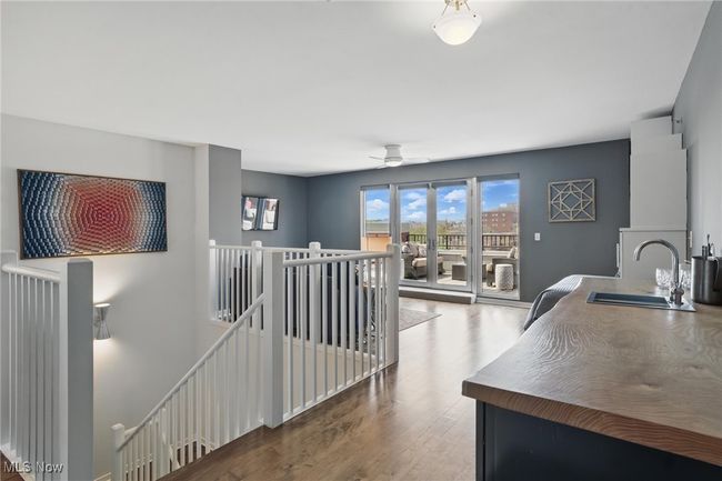 Hallway featuring wood finished floors, an upstairs landing, and a sink | Image 29
