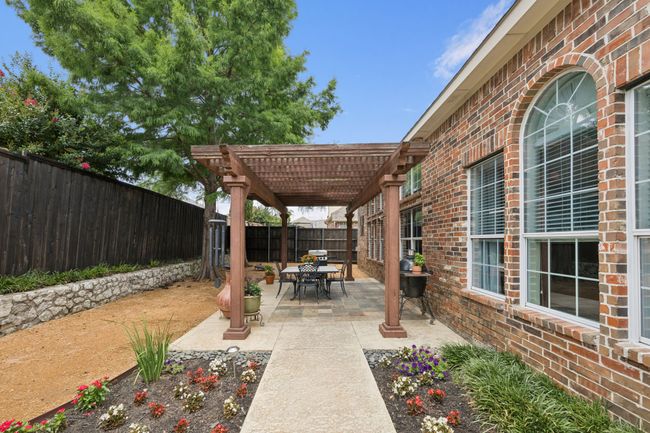 A paved walkway leads to the wrought iron fence surrounding the pool area. | Image 32