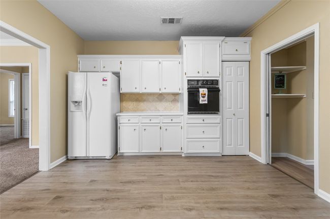 Kitchen with dishwasher, white cabinets & backsplash | Image 10