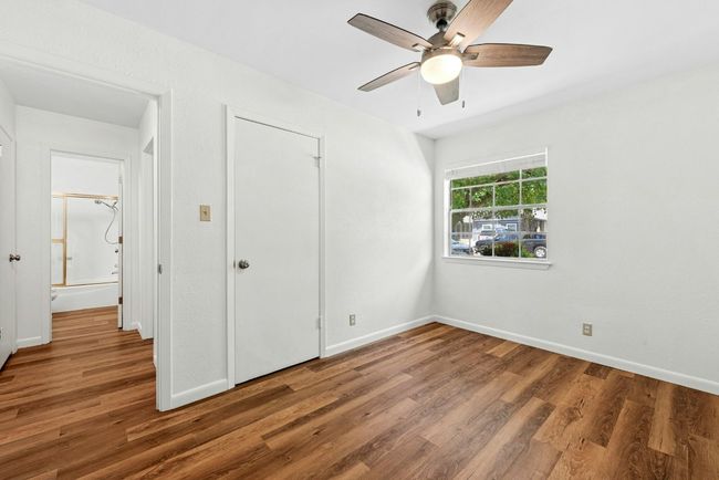 Unfurnished bedroom featuring wood finished floors and a ceiling fan | Image 16