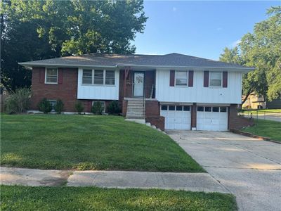 Raised ranch with a garage and a front yard | Image 1