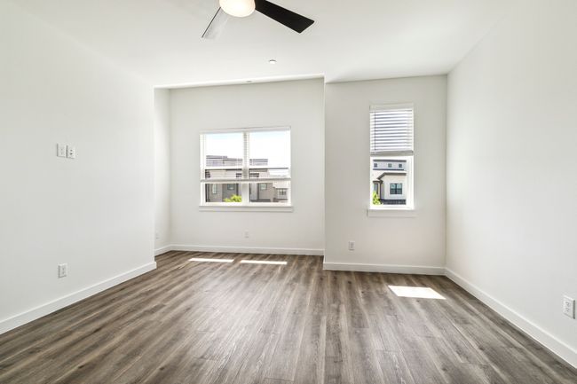 Unfurnished room with ceiling fan, healthy amount of natural light, dark wood finished floors, and baseboards | Image 18