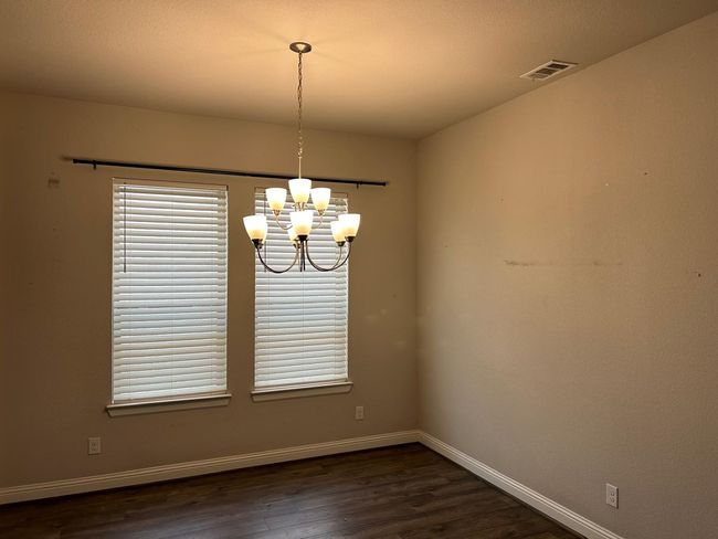 Dining area with a chandelier, baseboards, and wood-style flooring | Image 10