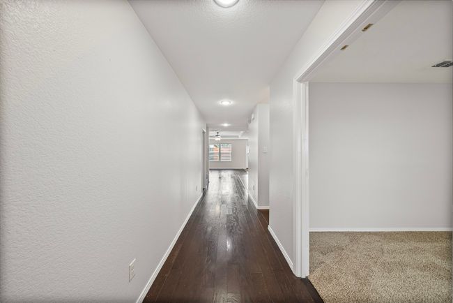 Hallway with baseboards and dark wood-type flooring | Image 7