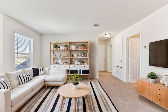 Living area with light carpet and visible vents | Image 15