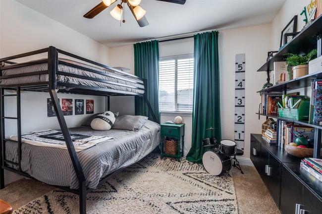 One of the first of the secondary bedrooms with ceiling fan, window view of backyard, good size closet and across the hall from the bathroom. | Image 11