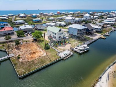 Aerial view featuring a water view with the boat launch, boat lift and sitting deck | Image 3