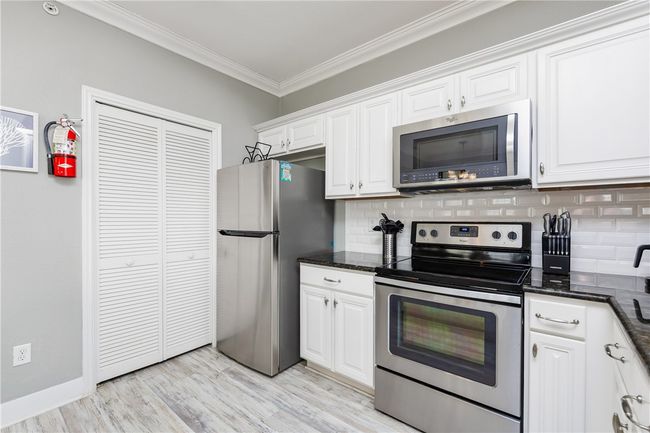Closet with washer/dryer inside. | Image 15