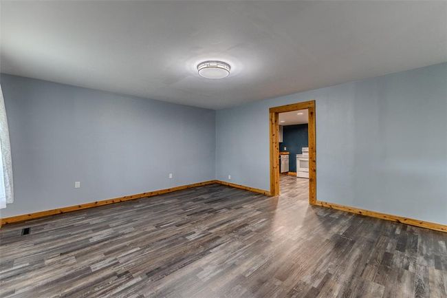 Unfurnished room with dark wood finished floors and baseboards | Image 8