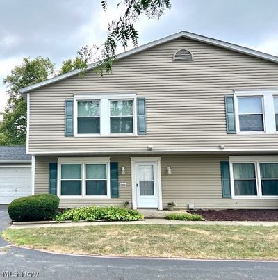 View of front of property with a garage and a front yard | Image 1