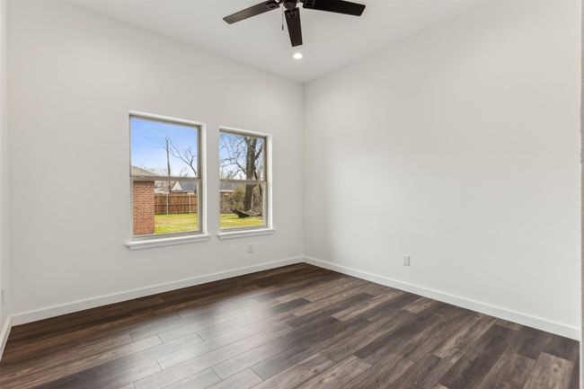 Unfurnished room featuring dark wood-style floors, a ceiling fan, and recessed lighting | Image 25