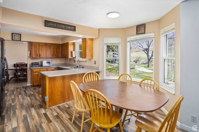 Dining space featuring dark wood finished floors and baseboards | Image 8