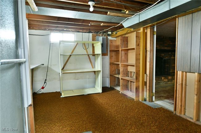Below grade area featuring electric panel and carpet floors | Image 42