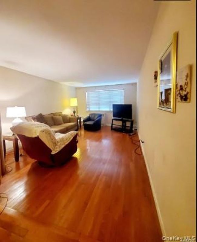 Living room with wood finished floors and baseboards | Image 21