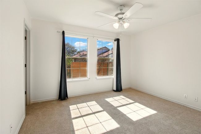 Unfurnished room with baseboards, light carpet, and ceiling fan | Image 15