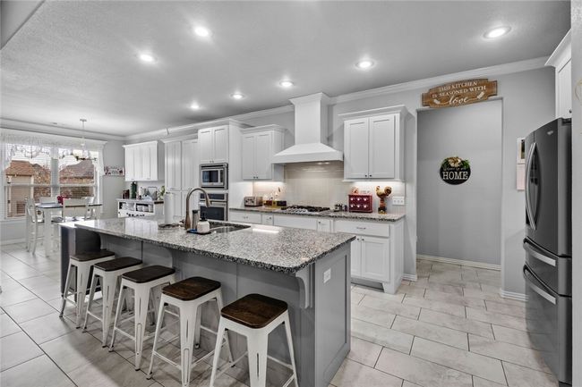 Beautiful open kitchen and breakfast room. Split floor plan with bedrooms 3 and 4 through the open doorway. | Image 11
