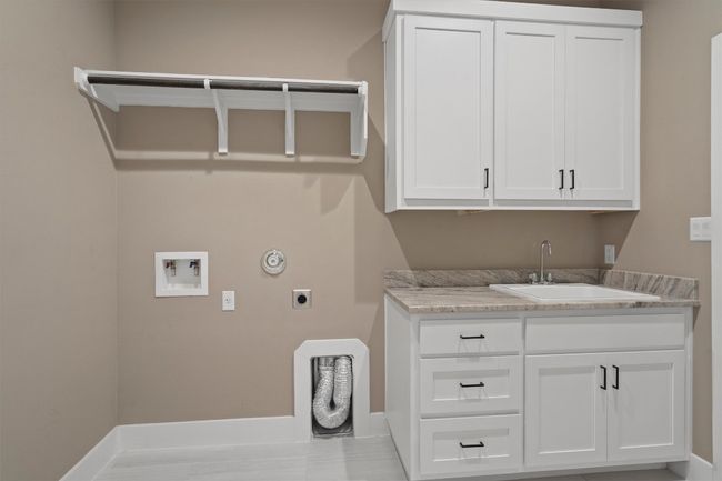 Laundry area with electric dryer hookup, washer hookup, and cabinet space | Image 19