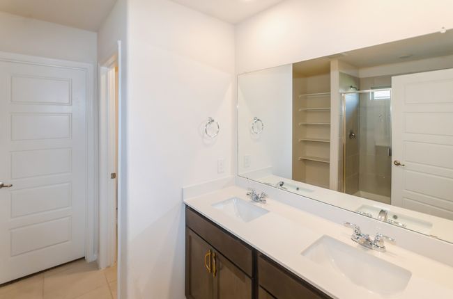 Bathroom with tile patterned floors, double vanity, and a stall shower | Image 17