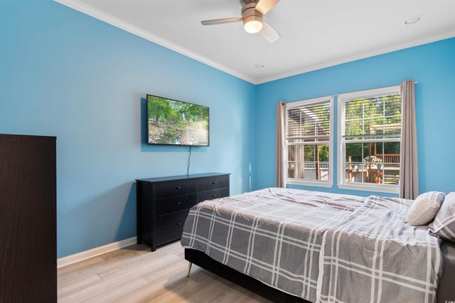 Bedroom with light wood-style floors, baseboards, ornamental molding, a ceiling fan, and recessed lighting | Image 19