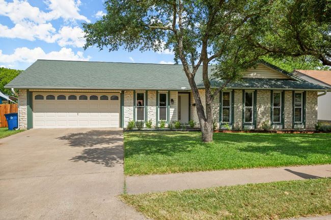 Ranch-style home featuring stone siding, driveway, an attached garage, and roof with shingles | Image 27