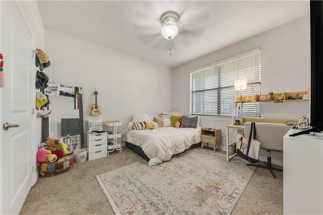 Bedroom with carpet flooring and ceiling fan | Image 15