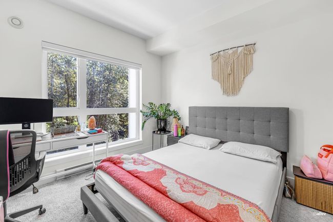 Carpeted bedroom with a desk | Image 13