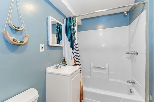 Full bath with shower / bath combination with curtain, vanity, and toilet | Image 16