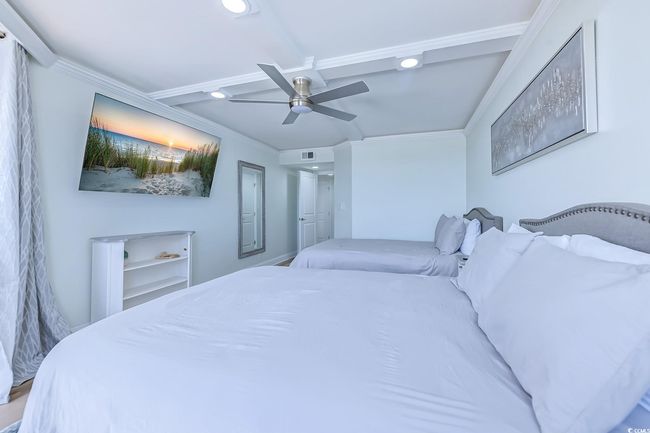 Bedroom with ornamental molding, wood-type flooring, and ceiling fan | Image 23