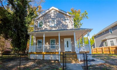 Farmhouse-style home featuring a porch | Image 2