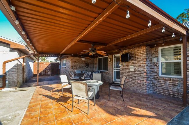 Imagine kickin' back under this outdoor patio, chatting it up with friends and watching the big game, cheering for your favorite team! | Image 22