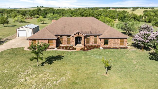 View of front facade with an outdoor structure, brick siding, and a front yard | Image 34