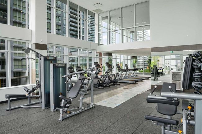 Workout area featuring a high ceiling | Image 16