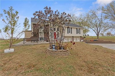 View of front of house featuring a front yard and a garage | Image 2