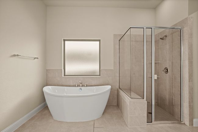 Bathroom with a stall shower, a freestanding bath, and tile patterned floors | Image 15