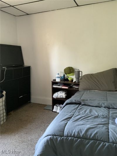 Carpeted bedroom featuring a drop ceiling | Image 3