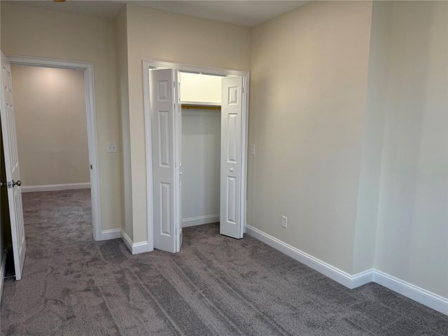 Unfurnished bedroom with carpet floors and a closet | Image 7