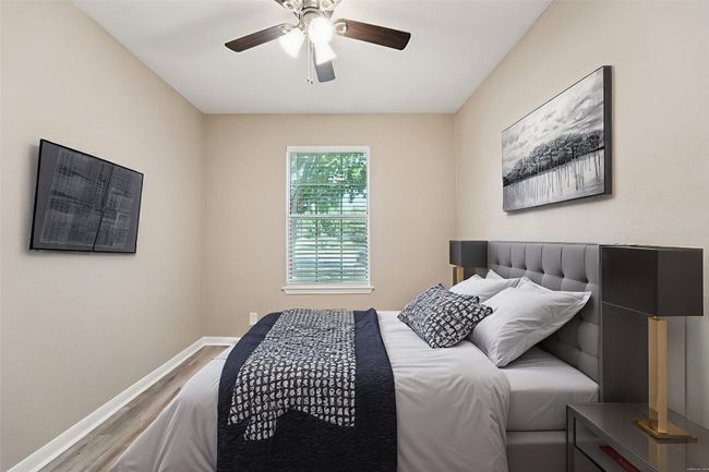 Bedroom featuring wood finished floors and ceiling fan | Image 4