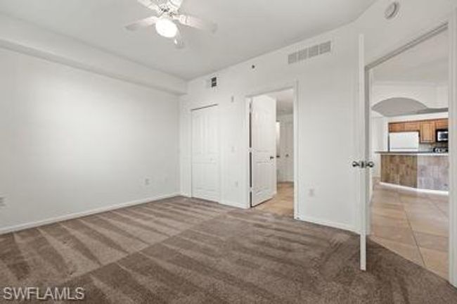Unfurnished bedroom featuring carpet, visible vents, refrigerator, and baseboards | Image 20