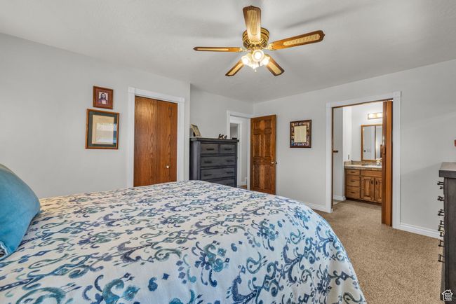 Master Bedroom 1. Carpeted bedroom with baseboards, a closet, ceiling fan, and ensuite bathroom | Image 14