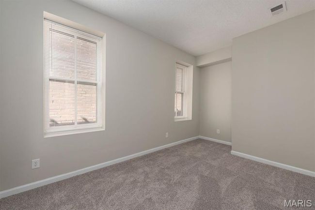 Empty room featuring carpet floors and healthy amount of natural light | Image 15