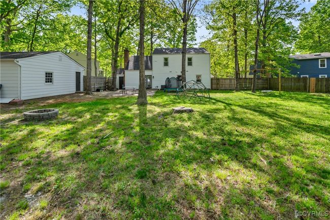 View of yard featuring a fire pit and a fenced backyard | Image 24