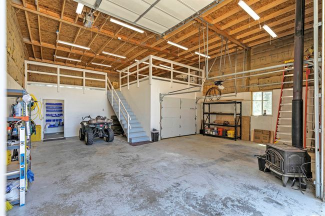 Inside of heated shop featuring a wood stove | Image 62