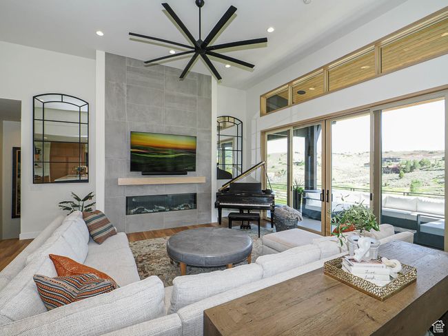 Living room with a fireplace, wood finished floors, and recessed lighting | Image 26