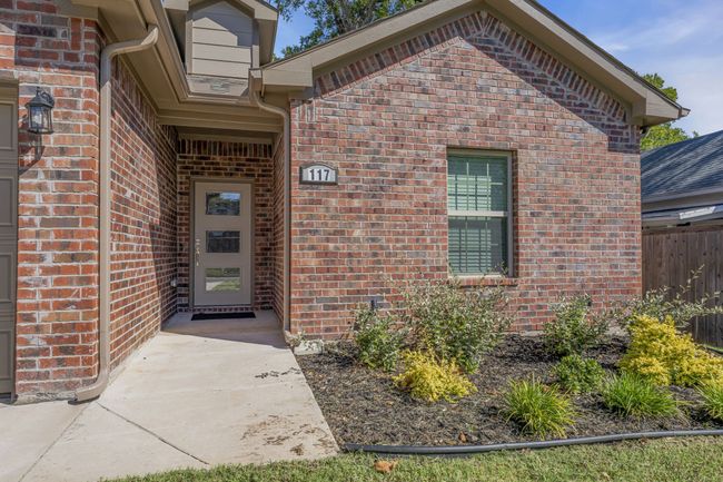 Entrance to property with fence and brick siding | Image 4