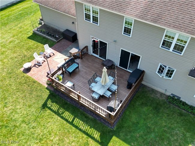 Back of house with a deck, roof with shingles, outdoor lounge area, and a lawn | Image 7