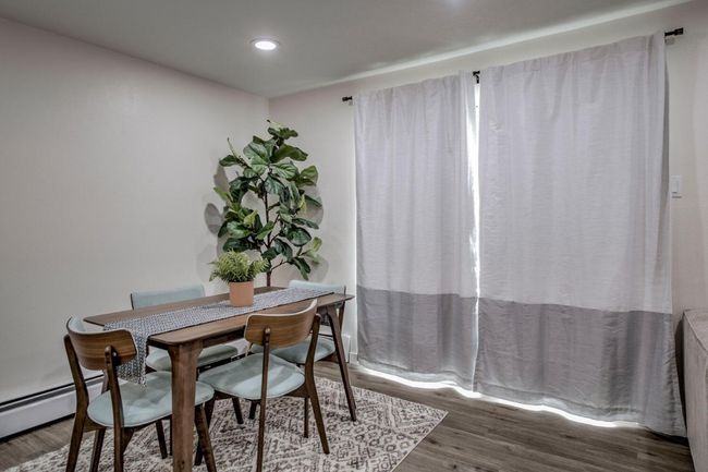 Dining area featuring baseboard heating, recessed lighting, and wood finished floors | Image 9
