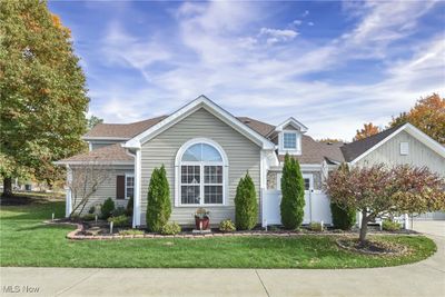 View of front of home featuring a front yard and a garage | Image 1